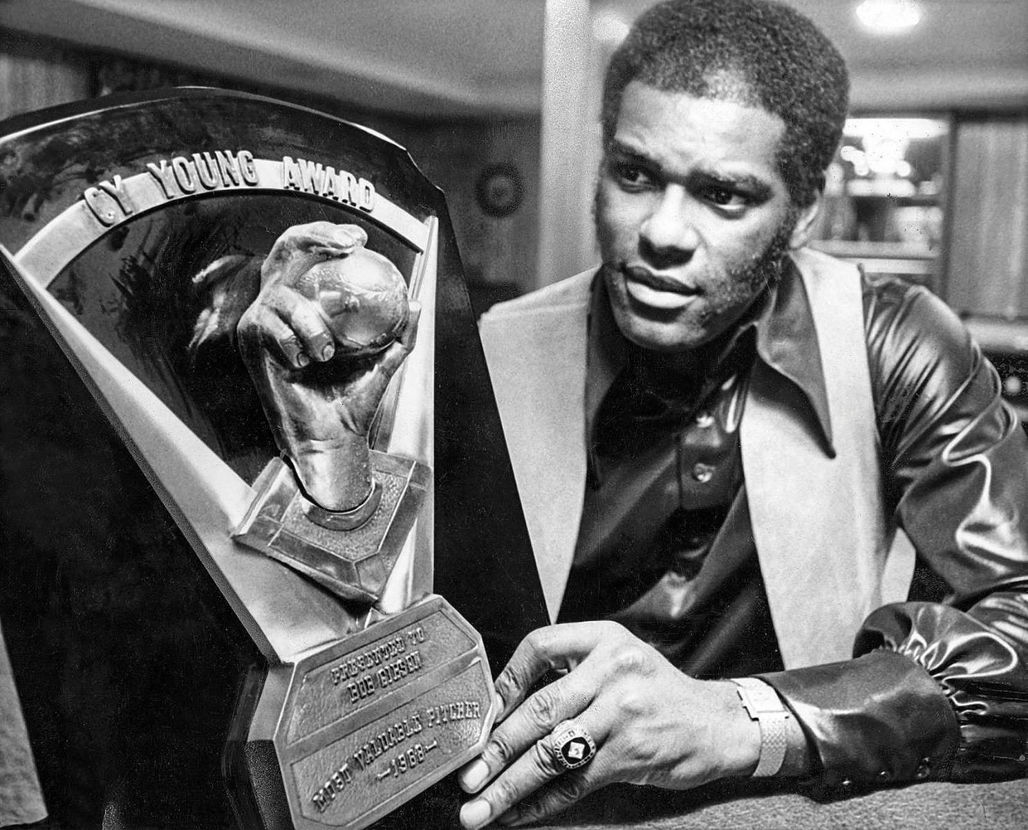 Bottom right, Gibson at home with his 1968 Cy Young Award.