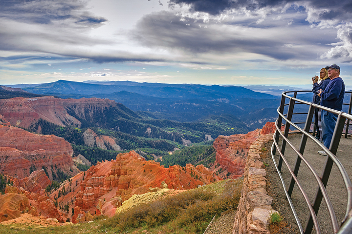 Cedar Breaks National Monument visitors admire sweeping views over mountain valleys and red-rock canyons from Chessman Ridge Overlook. 