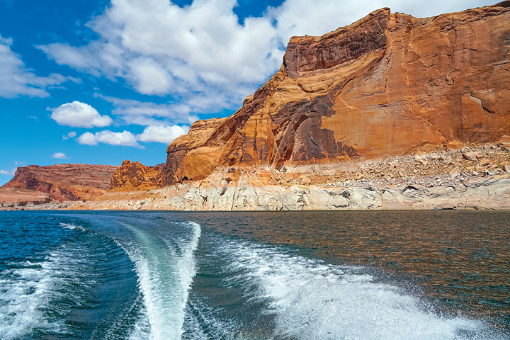 The Florence brothers’ houseboat, the Phoenix, leaves a wake on the waters of Lake Powell. 